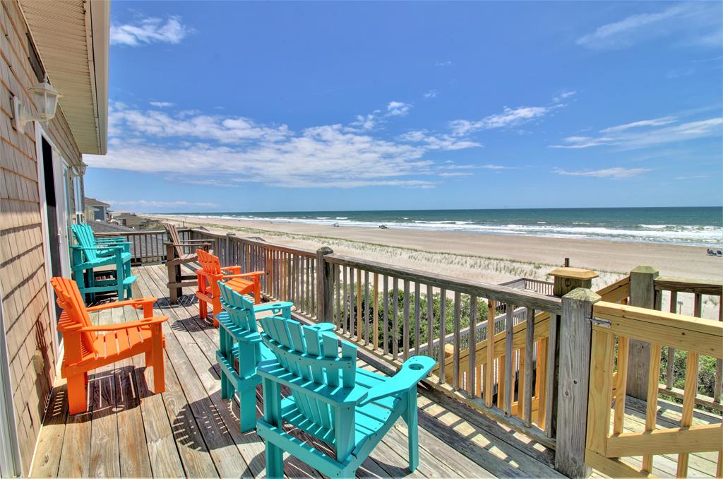 a deck with chairs and a beach view from a vacation rental in Surfside Beach